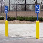 Yellow Bollard Sign Systems with blue posts used for handicap accessible parking spots
