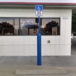 Blue Bollard Sign System used at a handicap accessible parking spot at a gas station