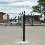 Black Channelizer traffic post with white reflective stripe