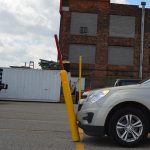 Flexible Bollard Sign System showing off its flexibility when contacted by a vehicle