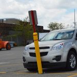 Flexible Bollard Sign System showing off its flexibility when contacted by a vehicle