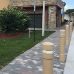 6-inch Architectural Decorative Bollard Covers with white reflective tape used to protect sidewalk pedestrians from parking lot traffic