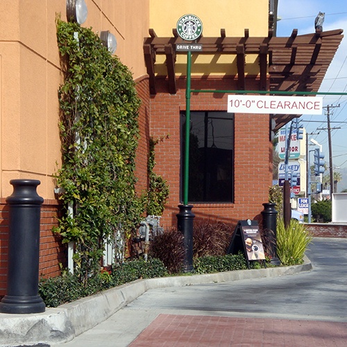 Black plastic Pawn Decorative Bollard Covers used for drive-thru protection at Starbucks