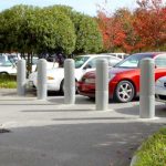 Light gray plastic Ribbed Decorative Bollard Covers used for parking lot protection