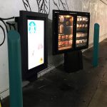 Forest green 6-inch Skyline Decorative Bollard Covers used to protect drive-thru order kiosk at Starbucks