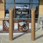 Metallic Bronze 6-inch Skyline Decorative Bollard Covers used for storefront protection