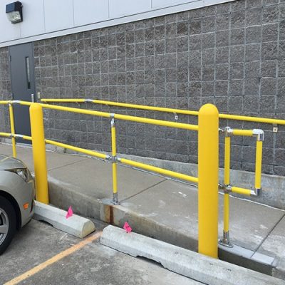 Yellow Pipe and Plastic Handrail on a ramp with bollard covers