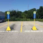 Yellow plastic Pyramid Sign Base used for designated truck parking spots